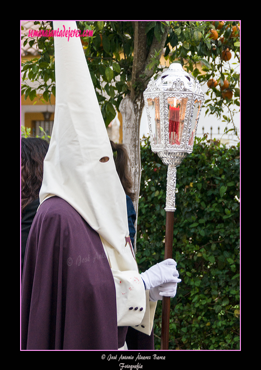 Nazareno con farol que acompaña a la Cruz de Guía de la Hermandad de la Entrega